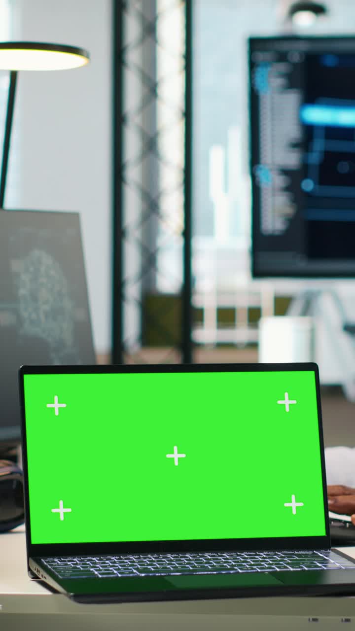 Vertical video Startup office programmer using green screen laptop, developing AI models