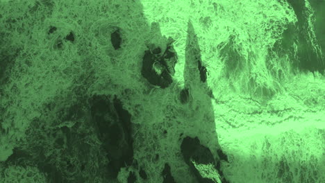aerial view of waves crashing on rocky coast