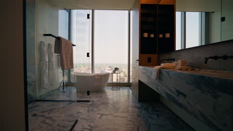 push in shot of a contemporary bathroom in a high-rise apartment, featuring a sleek and modern design with a luxurious freestanding bathtub as the focal point