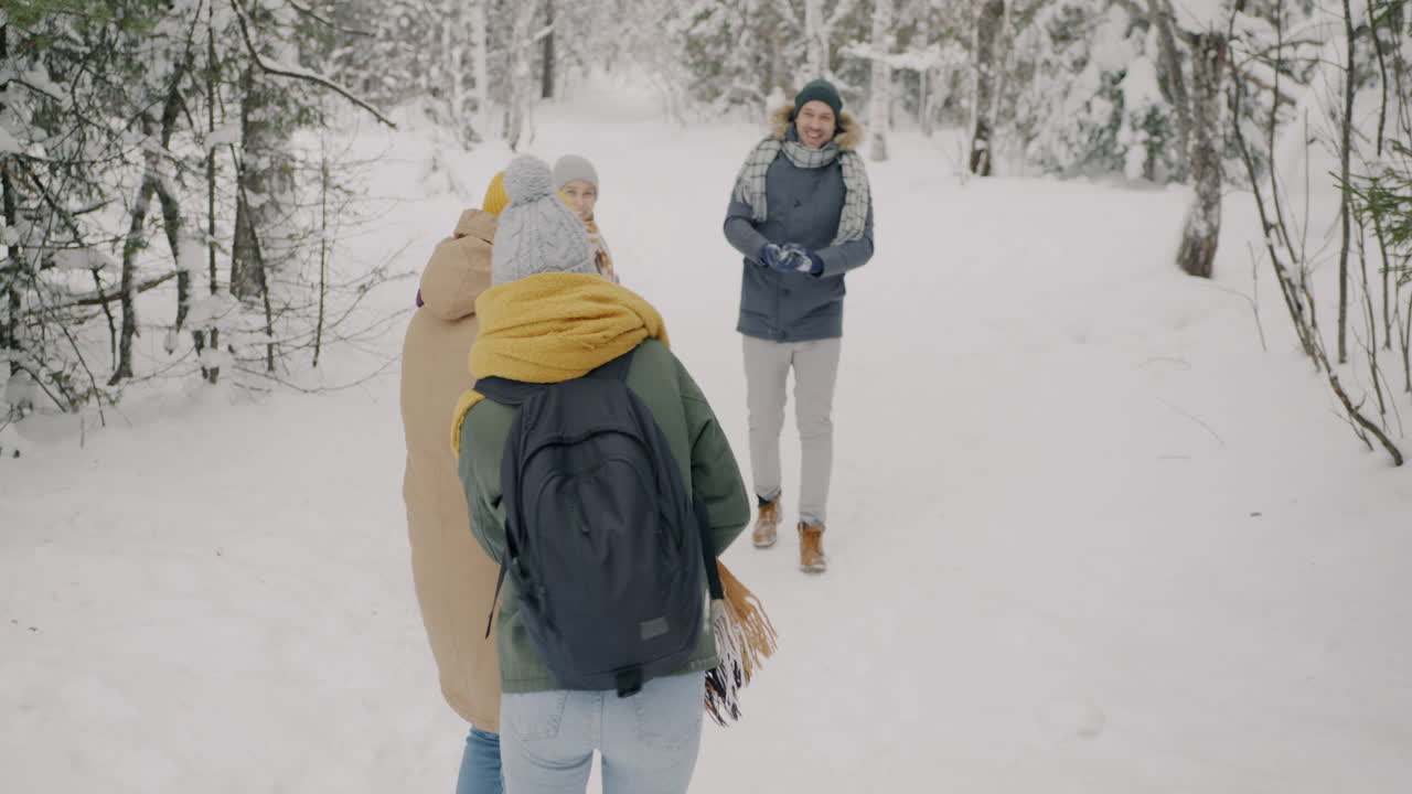 Friends Having Fun in the Snowy Forest