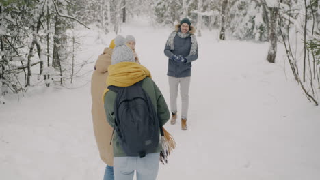 friends having fun in the snowy forest