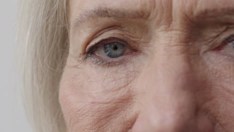 close up middle aged woman pretty blue eyes turns head looking at camera human beauty