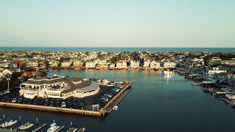 drone backing up over harbor in stoneharbor, new jersey during golden hour