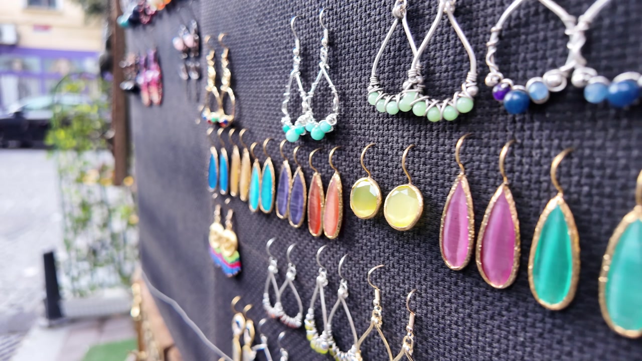 Close-Up of Colorful Handmade Earrings on Display at an Outdoor Market