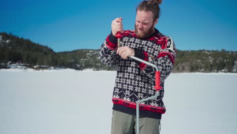 Person-Fixing-A-Hand-Auger-For-Drilling-A-Hole-During-Ice-Fishing