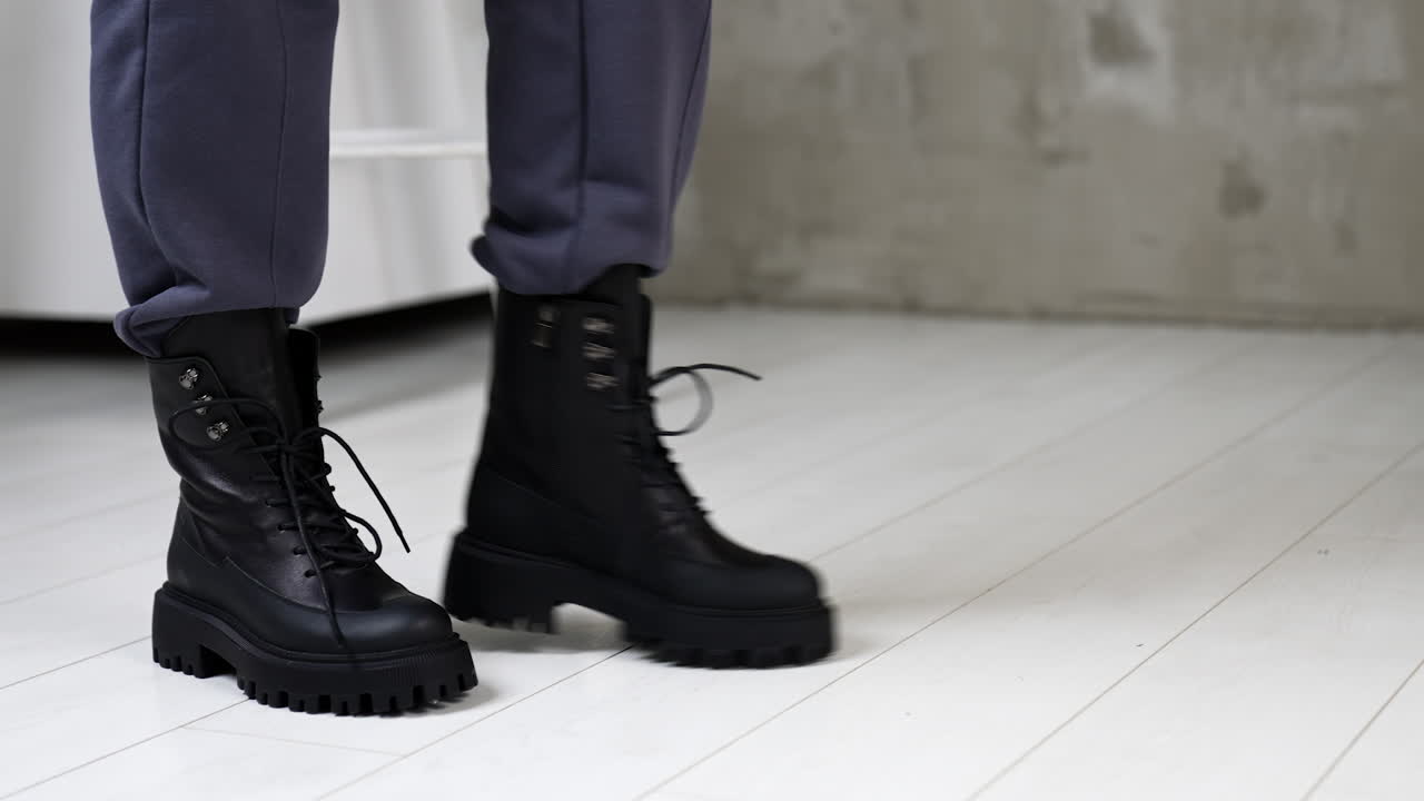 Stylish Black Chunky Boots on Gray Pants