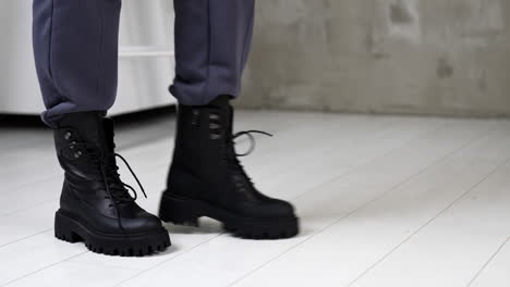 stylish black chunky boots on gray pants