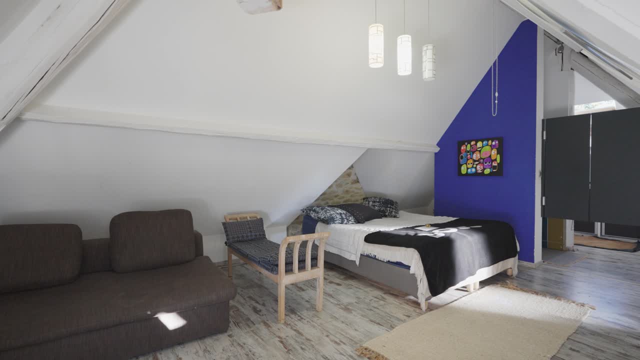 Slow revealing shot of a clean child's bedroom with sofas in the corner