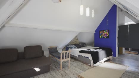 slow revealing shot of a clean child's bedroom with sofas in the corner