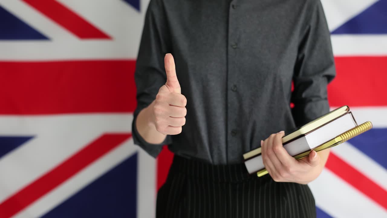 Person with books in front of the Union Jack flag