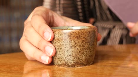 woman holding a small cup