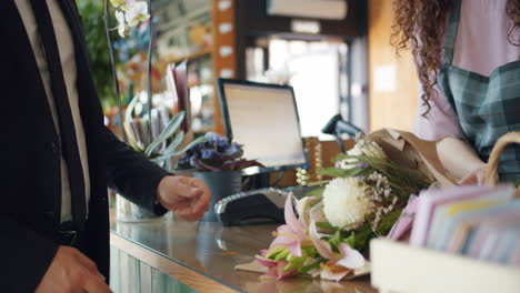 customer purchasing flowers at a florist shop