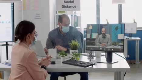 Freelancer-with-protective-face-mask-talking-with-collegue-during-virtual-videocall-conference