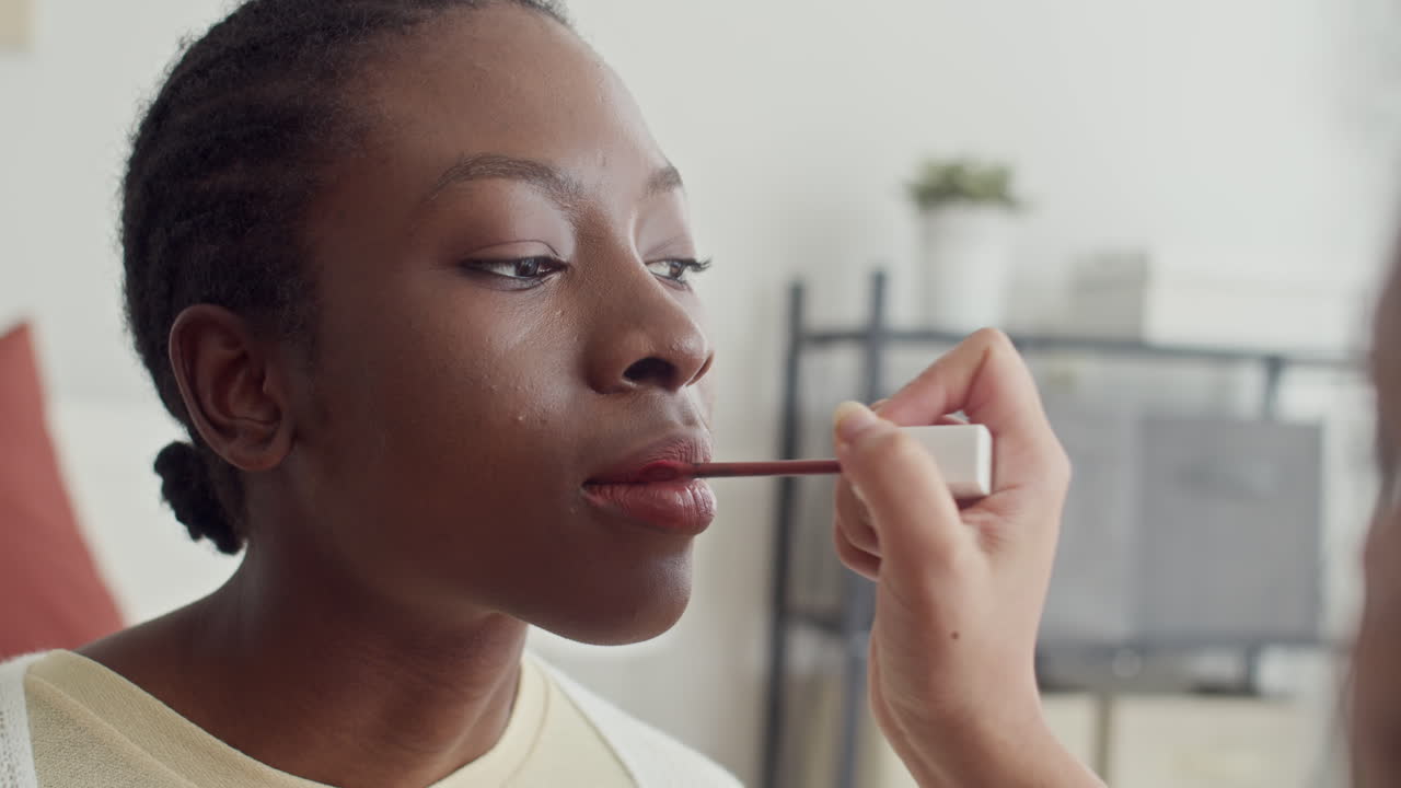Girl Applying Lipstick when Doing Makeup to Friend