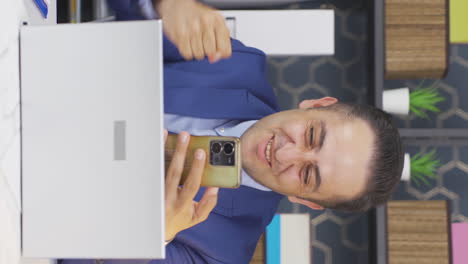 Vertical-video-of-Successful-businessman-rejoices.