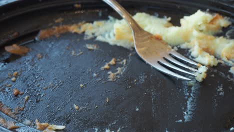 empty plate with leftover mashed potatoes and fork