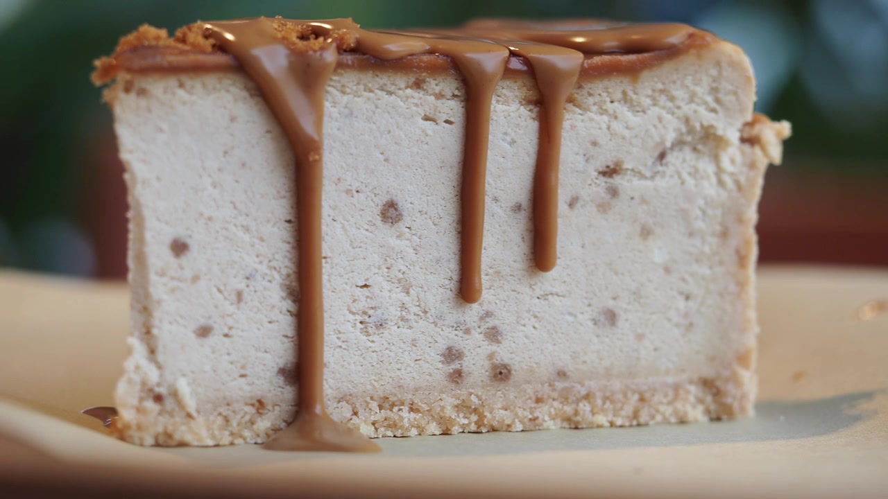 Caramel Sauce Drizzling Over a Slice of Cheesecake