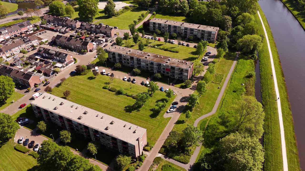 Aerial view of a European residential area with apartments, houses, and green spaces