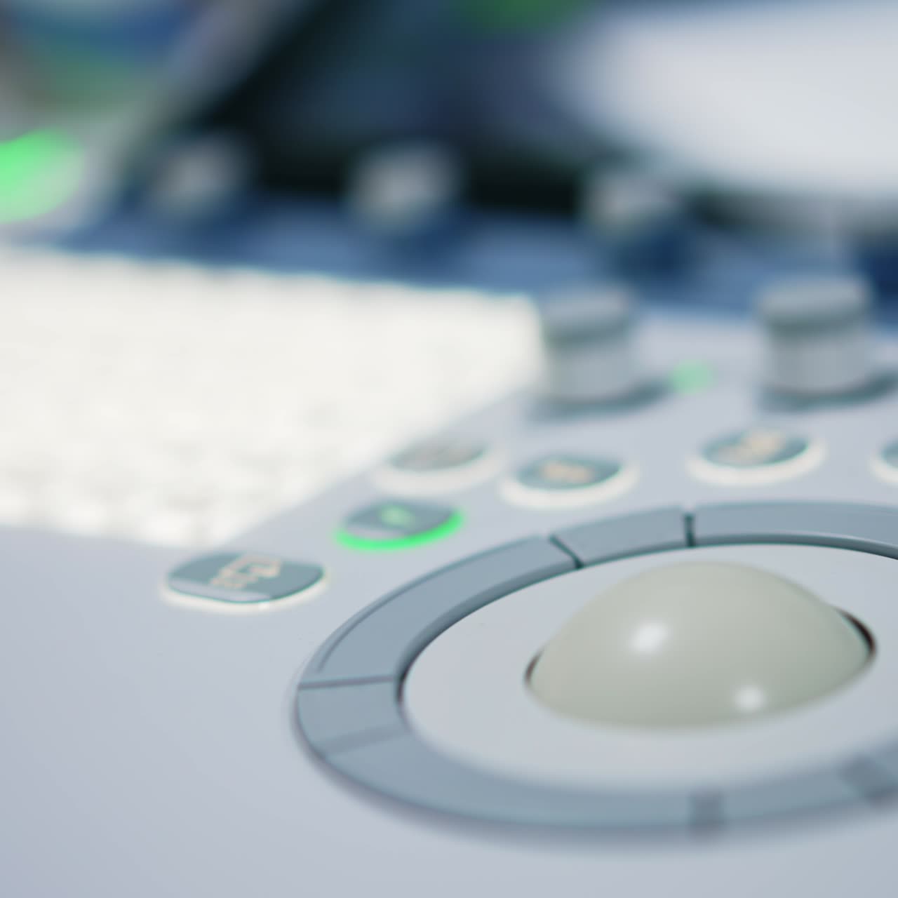 Closer look on keys and buttons of medical equipment in modern clinics. Ultrasound diagnostic machine. Blurred backdrop