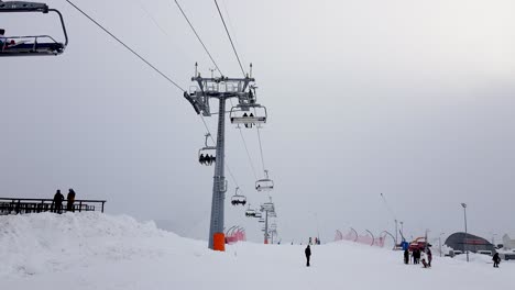 gudauri ski resort with ski lift and few people doing snow activities and sports in georgia