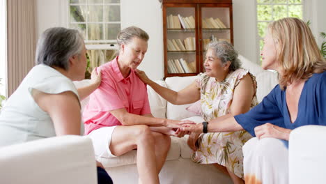 diverse group of senior women engage in a supportive conversation indoors