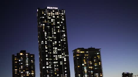 skyscrapers reflecting on water at dusk