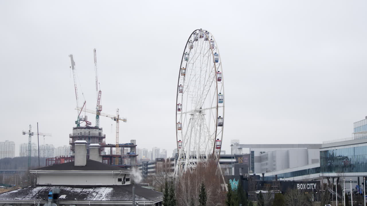 Cityscape with Ferris Wheel and Construction