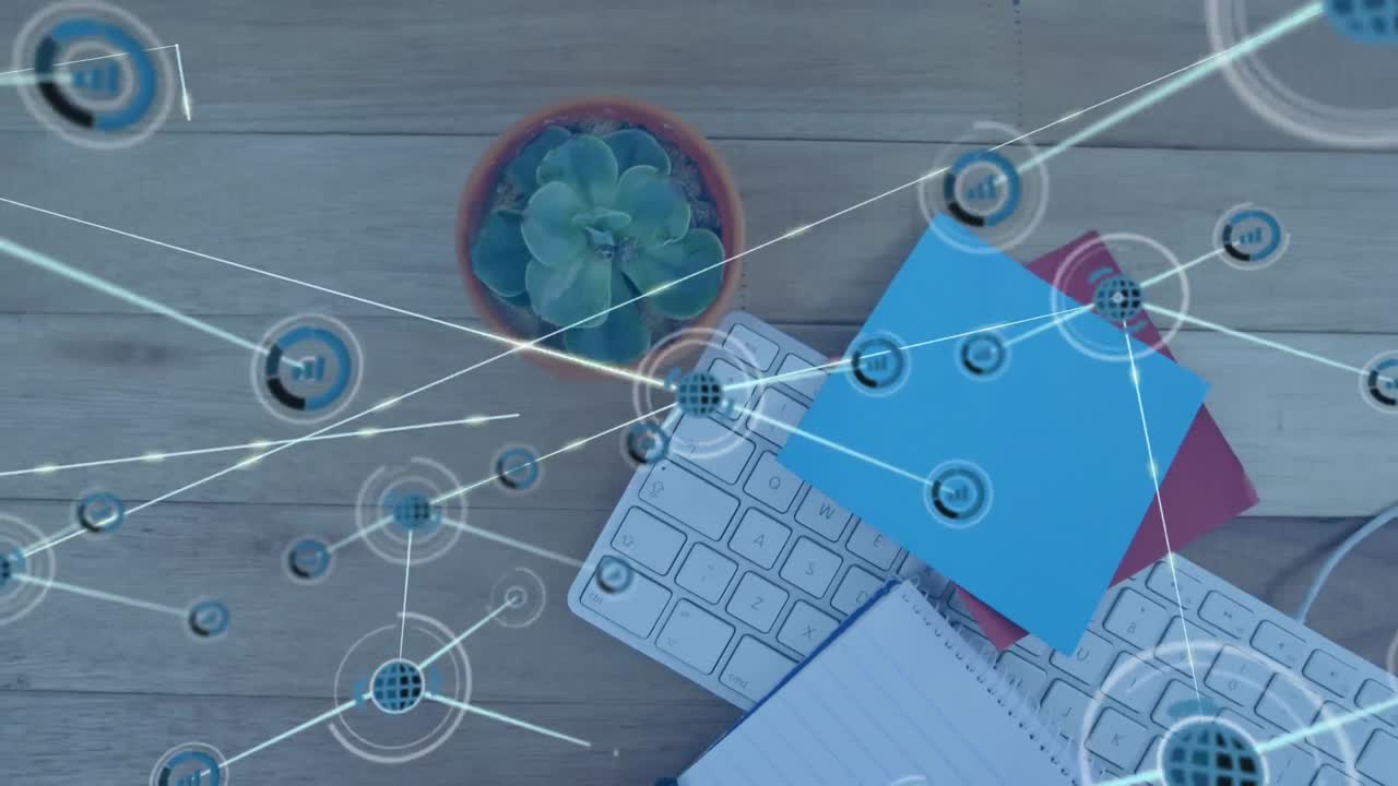 animación de una red de iconos digitales en primer plano de notas de nota, planta, teclado en una mesa de madera
