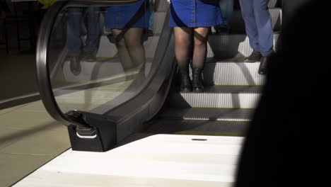 people using an escalator