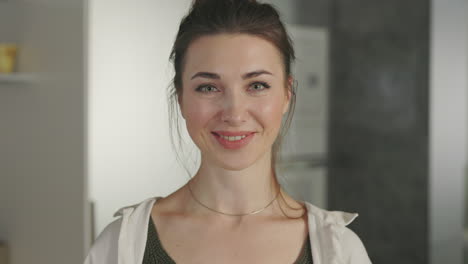 a woman smiling playfully with lemons