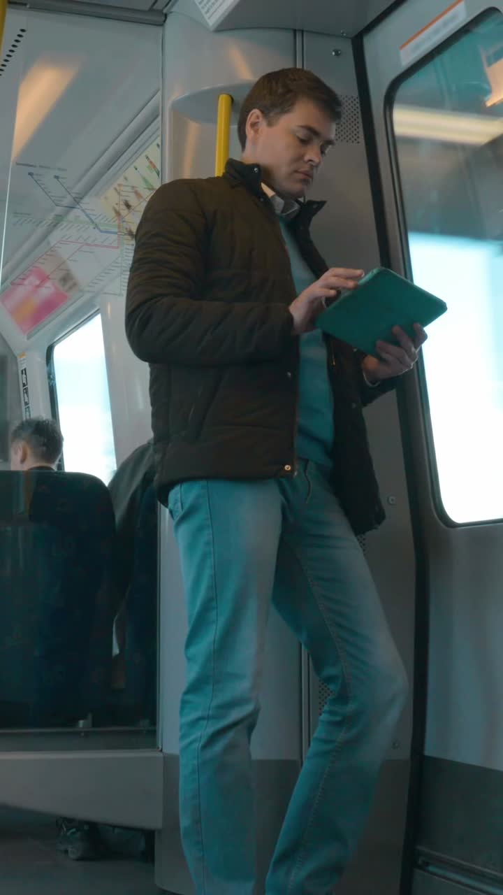 Man Using Tablet on Subway