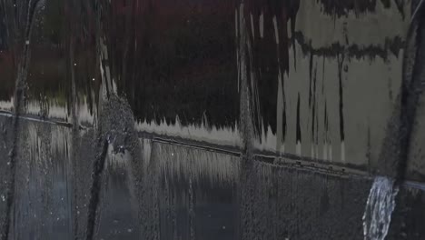 water falling off of a fountain wall into water in 120 fps slow motion