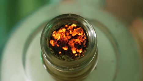 plant material burning in a small water pipe