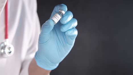 doctor holding a covid-19 vaccine vial