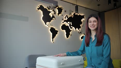 tourist woman with suitcase sitting near suitcase in airport. travel concept