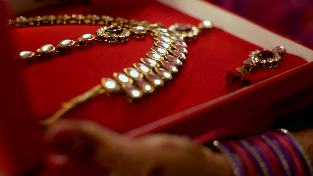 A female checking out kundan jewellery set / necklace set for festive preparation