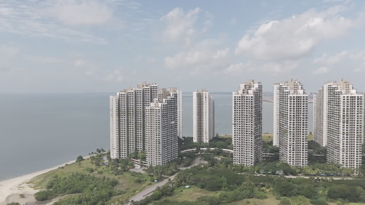 Aerial view of the Ataraxia towers in Forest City as the drone flies forward captured in dlog m color profile