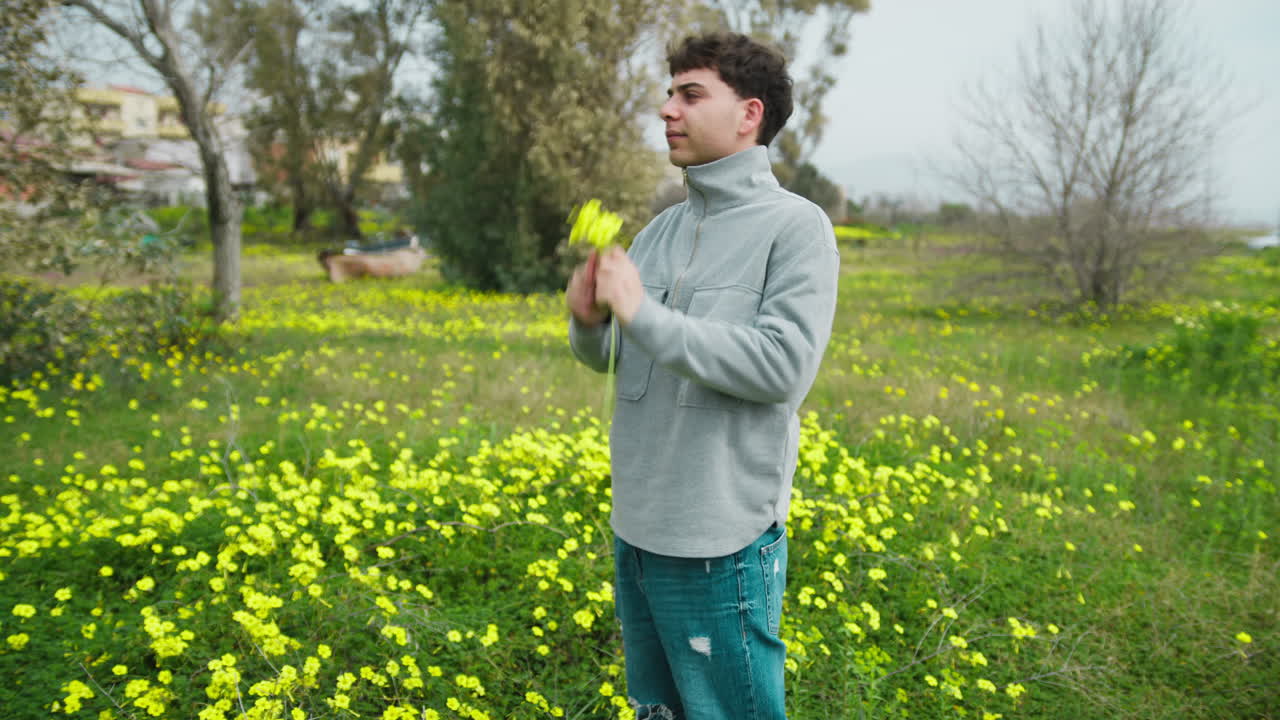 Happy Man Selecting The Flowers From The Ground For A Gift