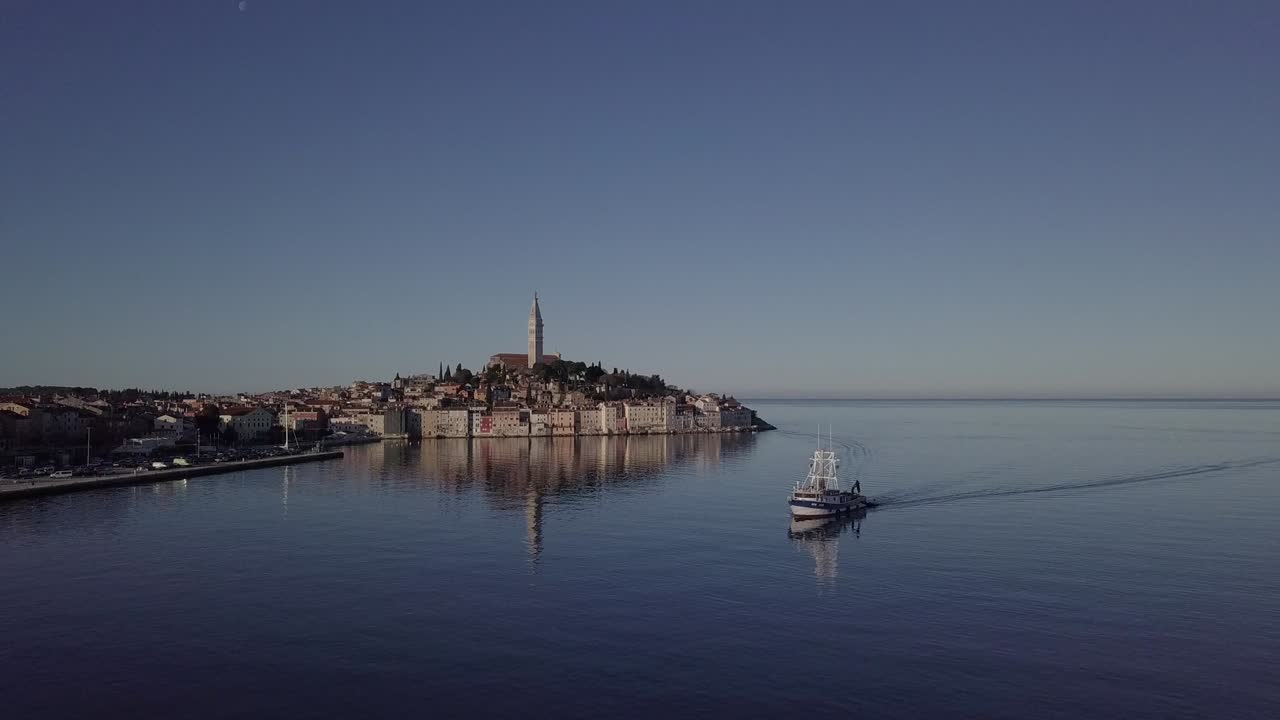 Morning aerial panorama of old town Rovinj, with fishing ship and reflection at the sea. Istria, Croatia. Original untouched LOG format.