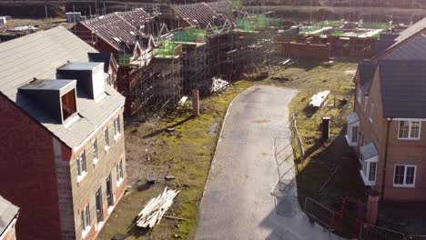 Flying-over-unfinished-waterfront-townhouse-property-development-construction-site-aerial-view