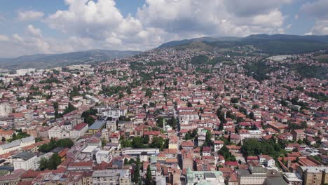 Breathtaking-view-of-Sarajevo's-dense-red-rooftops-amid-green-hills,-Bosnia
