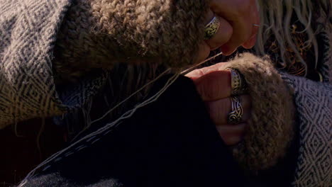 viking craftsman making woolen clothes using historical materials