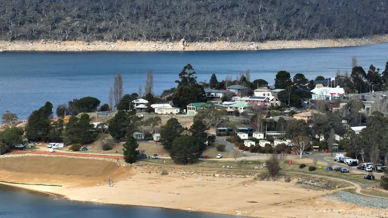 Long lens drone shot of a holiday park on the shores of Lake Jindabyne, Australia