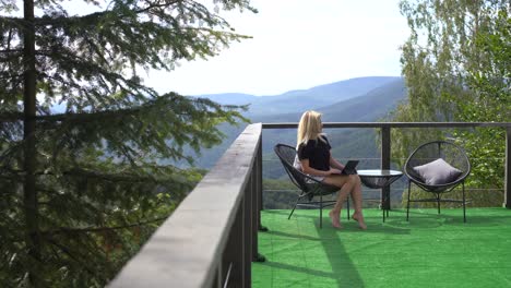 woman talking on a video call with a tablet sitting on a terrace