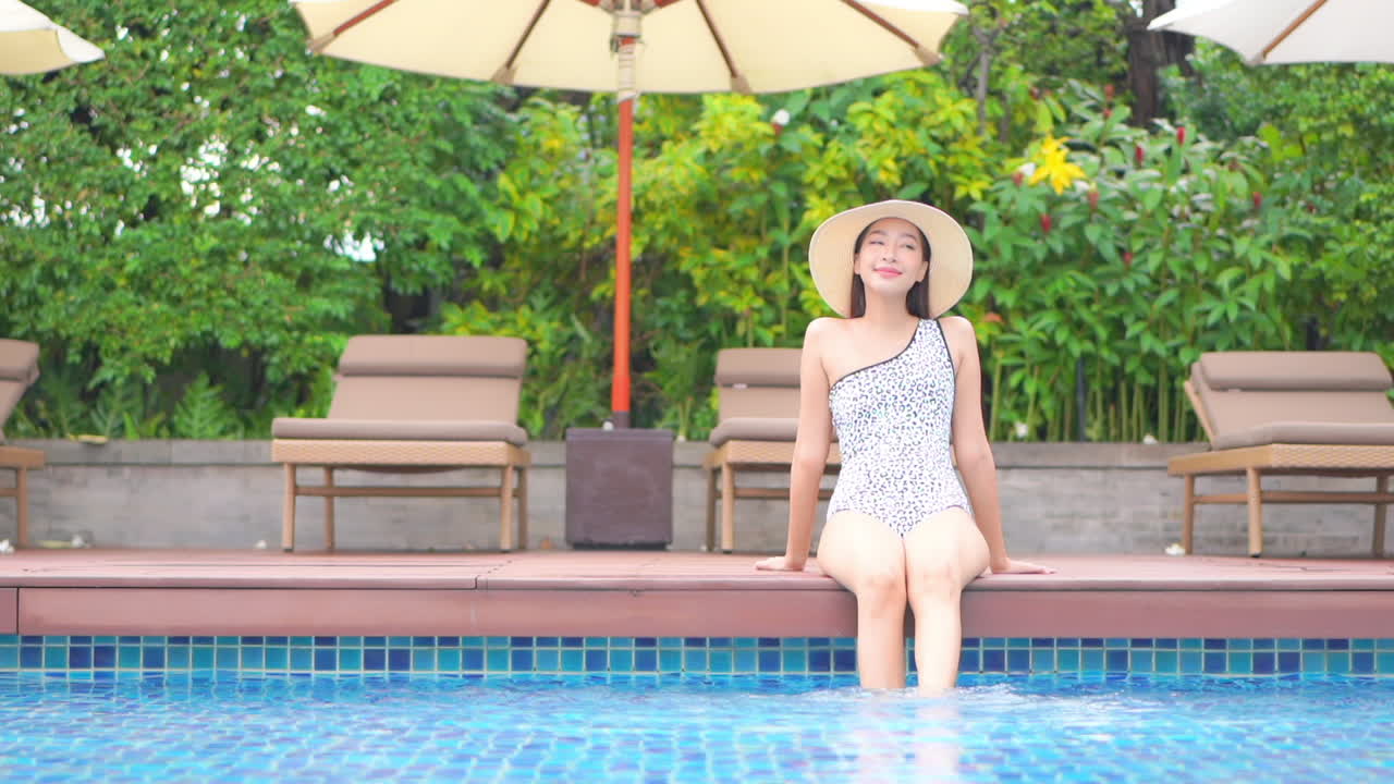 Fashionable Exotic Woman on Poolside of Luxury Hotel, Bathing Legs in Water, Full Frame Slow Motion