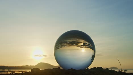 magic sunset view on the beach in a crystal ball.