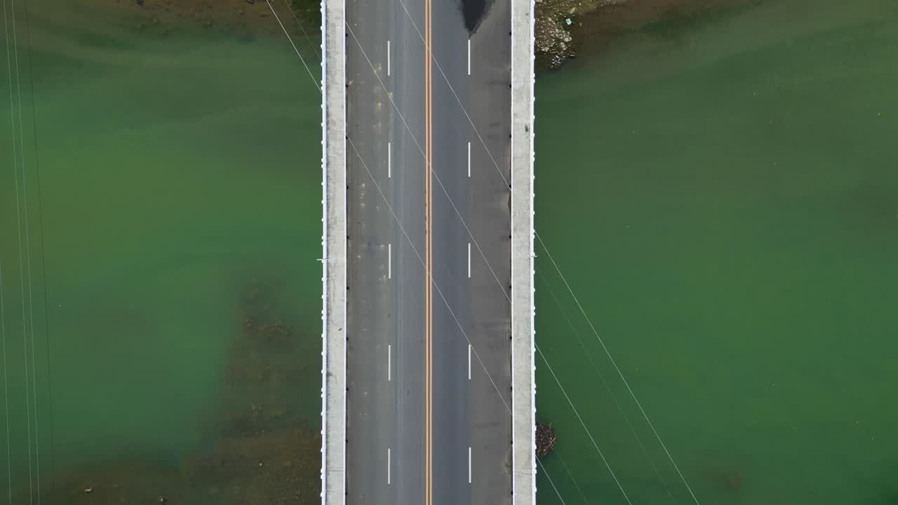 Top down tracking along Santo Domingo Bridge crossing water in Virac, Catanduanes, vehicle drive along road