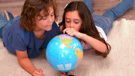Brother-and-sister-holding-a-globe