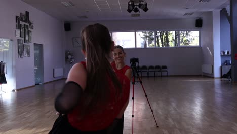 Professional-female-dancer-dances-on-the-dance-floor-in-front-of-the-mirror