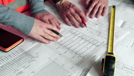 construction workers reviewing building plans